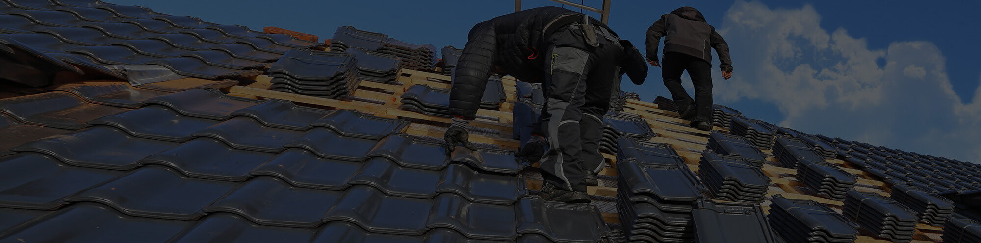 Roofing contractors installing new roof tiles on Green Bay home