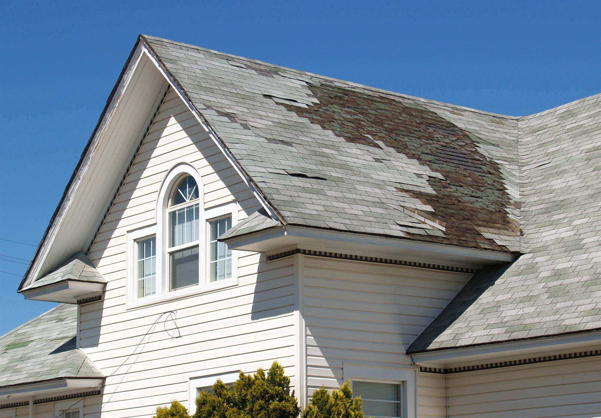 Damaged Roof with missing shingles in Green Bay, Wisconsin