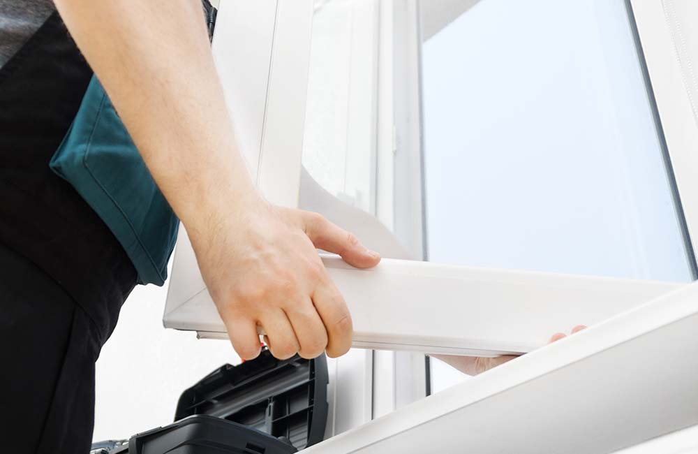 A contractor replacing a window in Green Bay