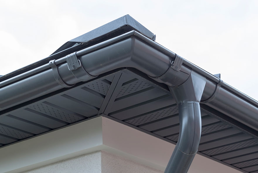 a dark grey soffit next to a gutter