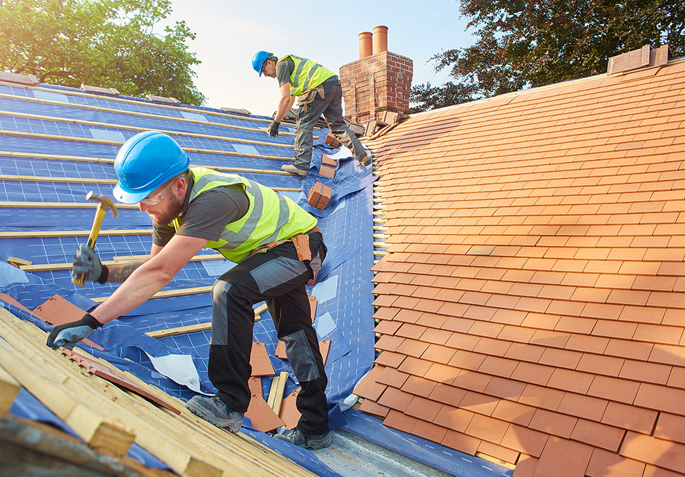 Two roofing contractor replacing Unified Steel roof shingles in Dayton, WI