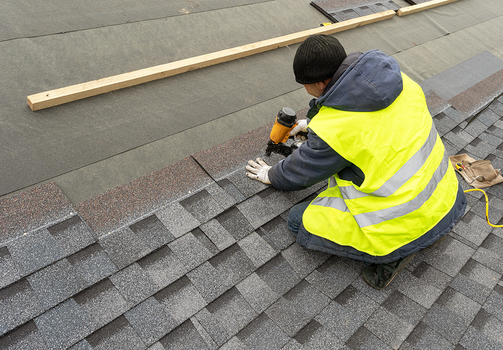 Roofing contractor in Waupaca, WI replacing asphalt shingles