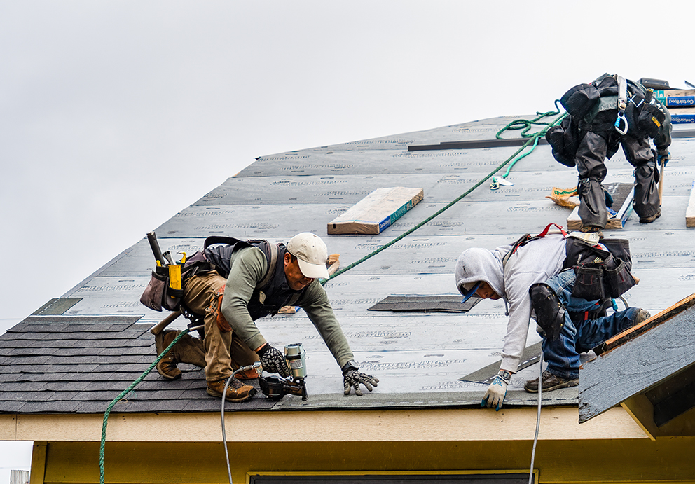 Roofing contractors waterproofing roof prior to asphalt shingle replacement in Brillion, WI