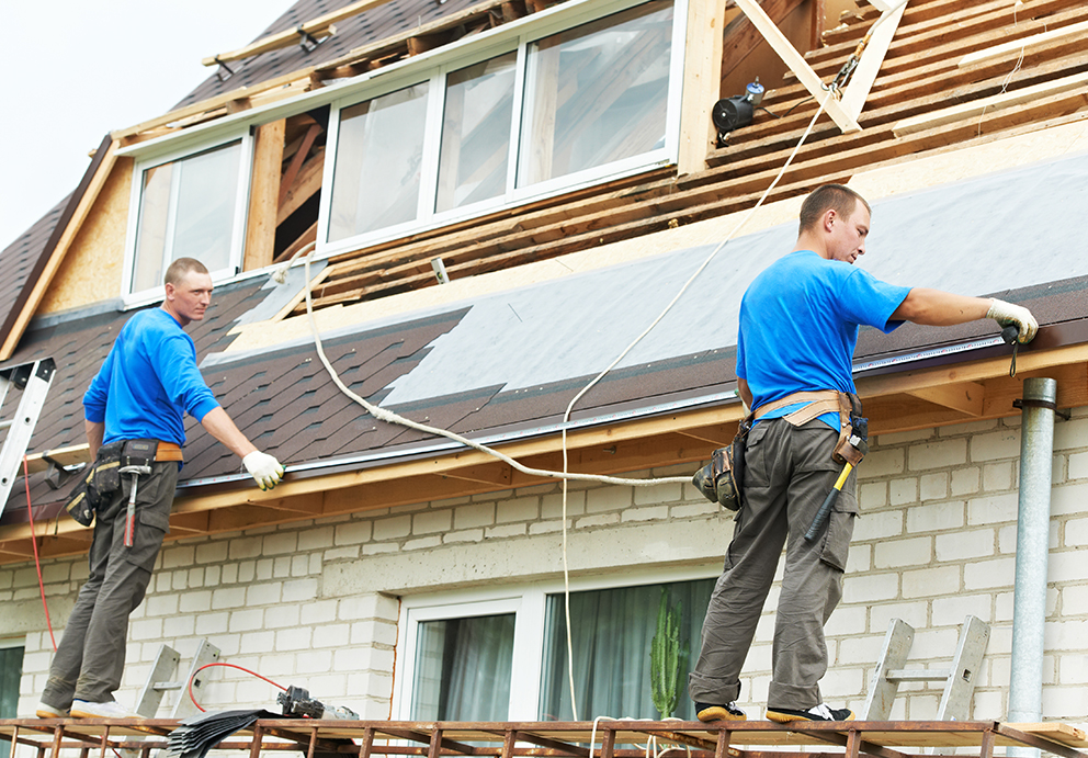 Roofing contractors replacing roof shingles and windows in Howard, WI