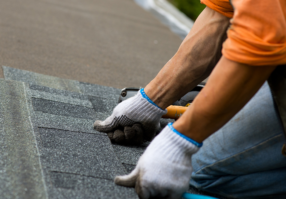 Roofing contractors in Manitowoc, WI installing new asphalt roof