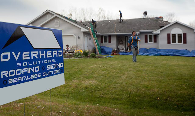 Emergency roof repair crew fixing asphalt roof in Green Bay, Wisconsin