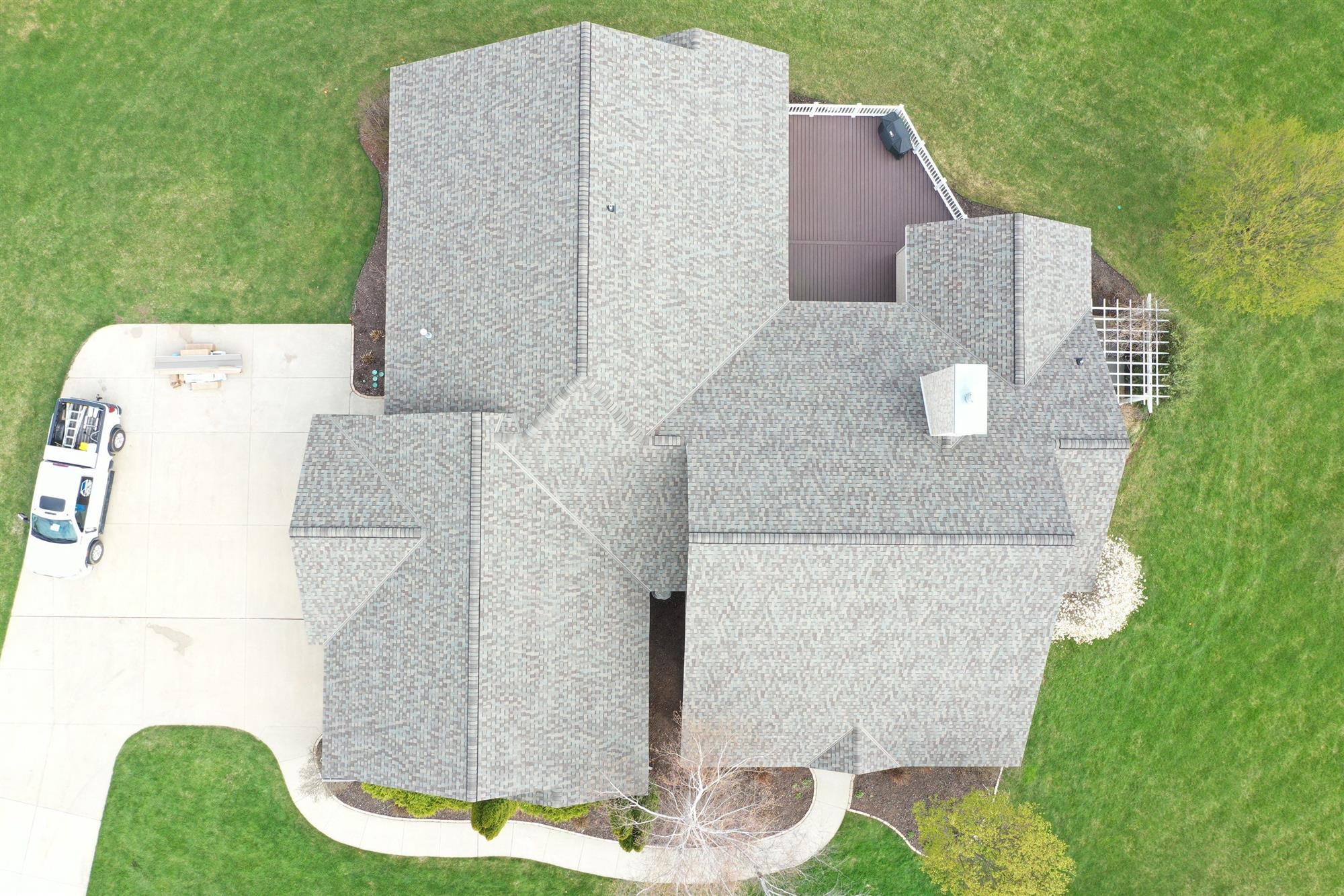 Large multi-story home with new asphalt shingles installed by Overhead Solutions in Green Bay, WI