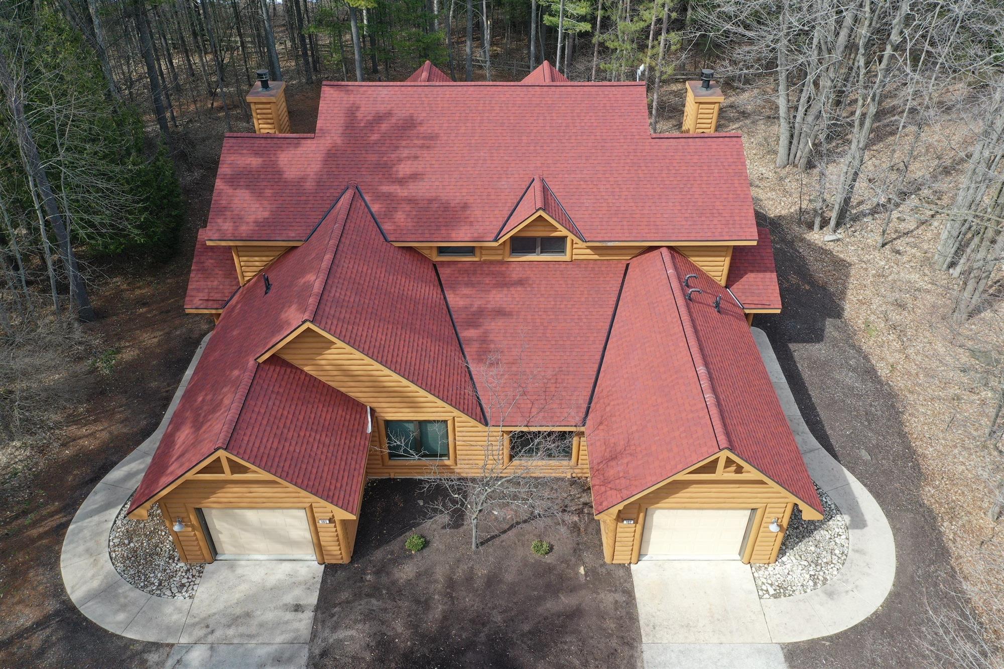 Roof Replacement for a log home in Green Bay, Wisconsin with red asphalt shingles installed by overhead solutions
