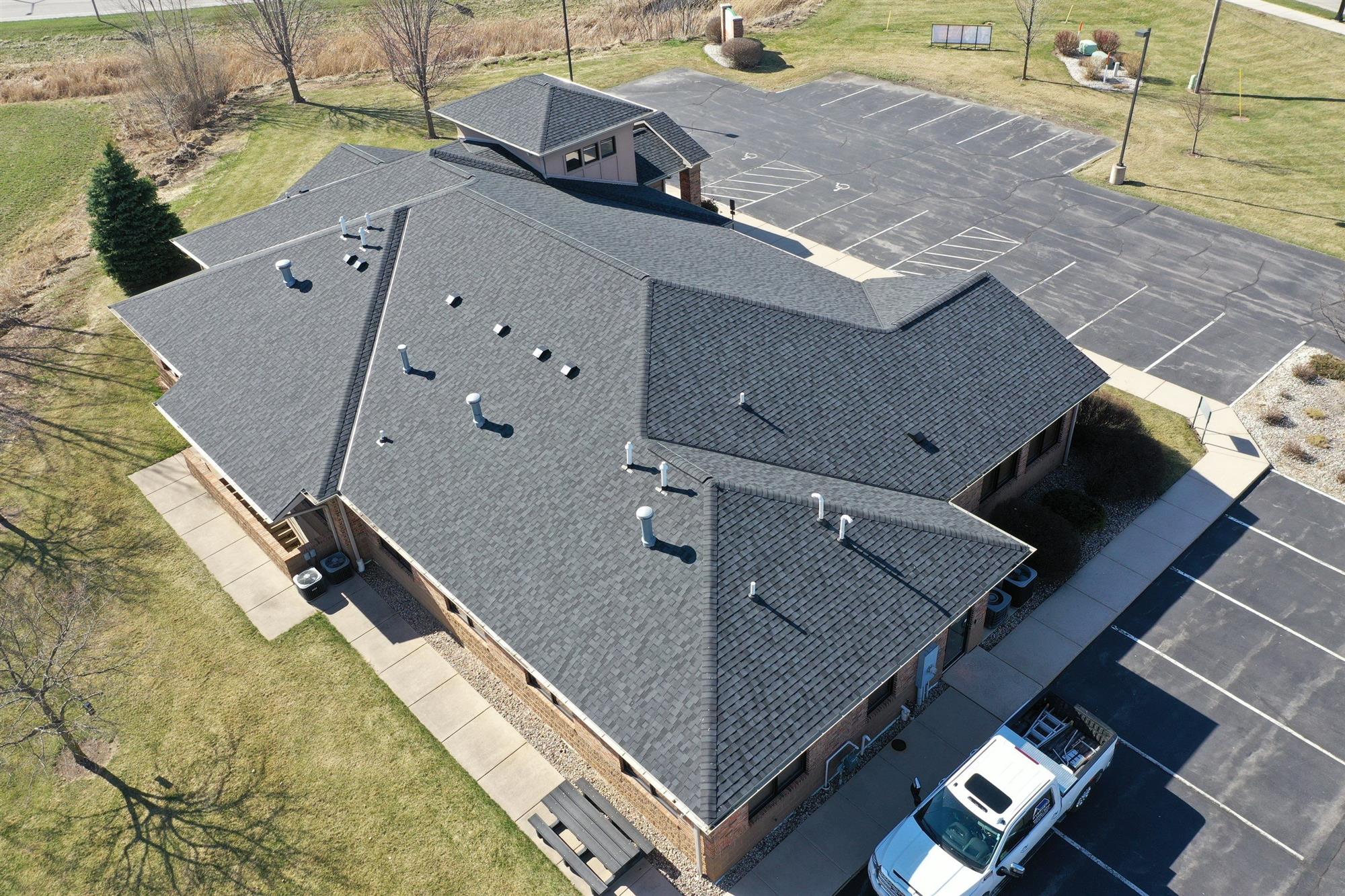 Commercial Roof Replacement Completed by Overhead Solutions with Dark Grey Shingles in Green Bay, WI