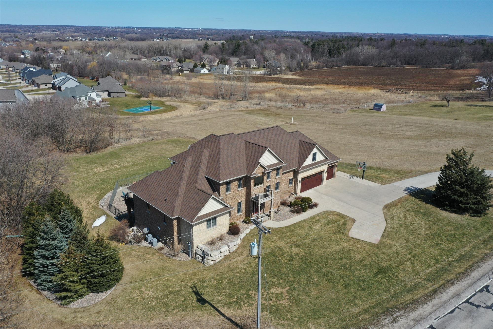 Large home with a brown roof newly replaced by Overhead Solutions in Green Bay, WI