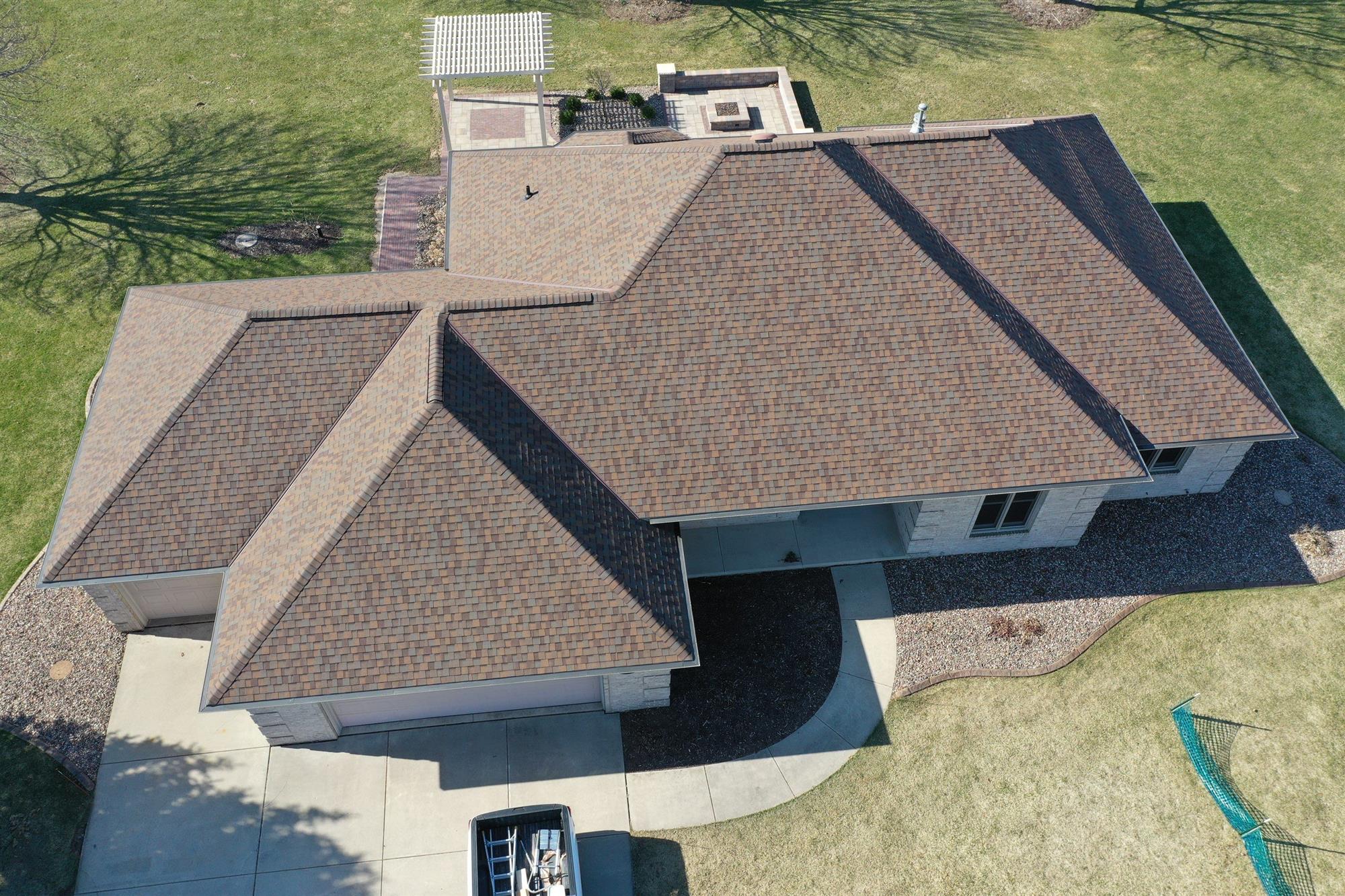 Large home with newly installed brown asphalt shingles in Green Bay, WI