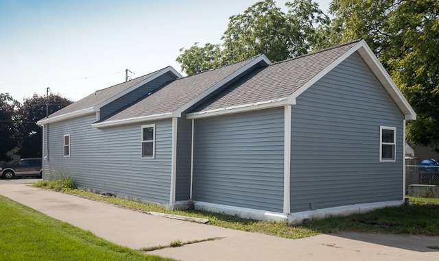 Blue Single-Story Home with New Asphalt Shingles Installed by Overhead Solutions in Green Bay