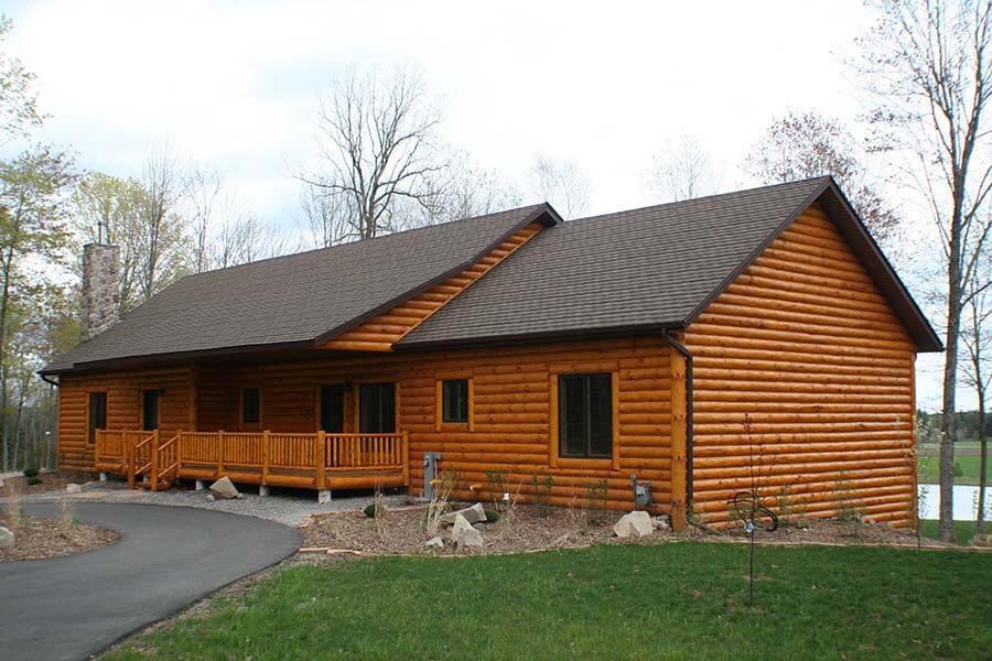 Roof Replacement on a log home with new asphalt shingles in Green Bay, WI.